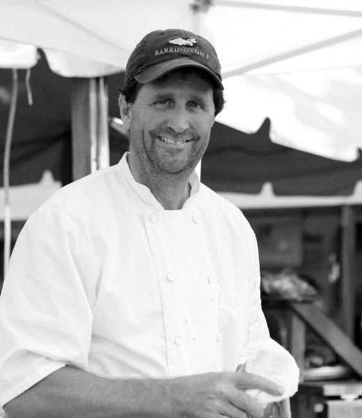 chef bruce moffett smiling in barringtons restaurant hat